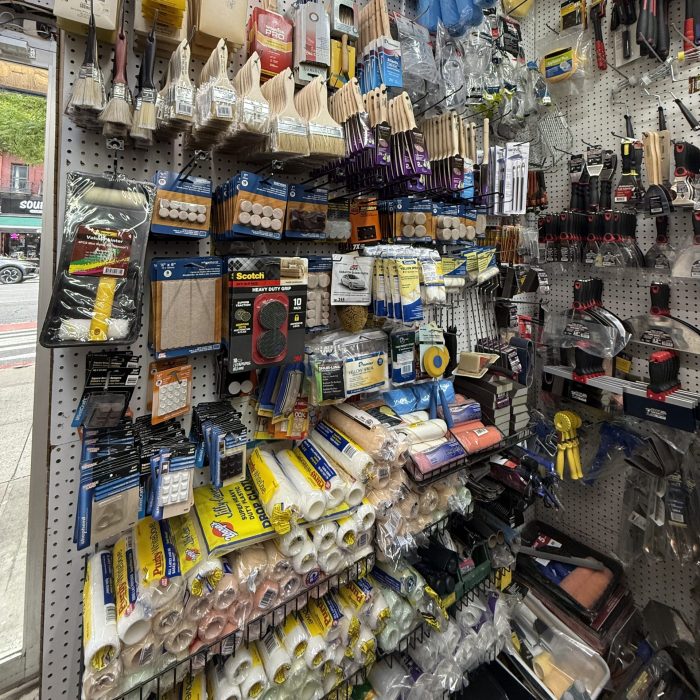 Paint cans and supplies stacked in the paint aisle